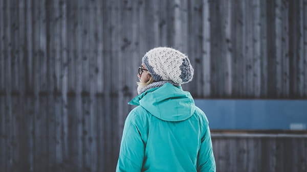 an image of a girl, looking away, wearing ice-cap and cyan jacket